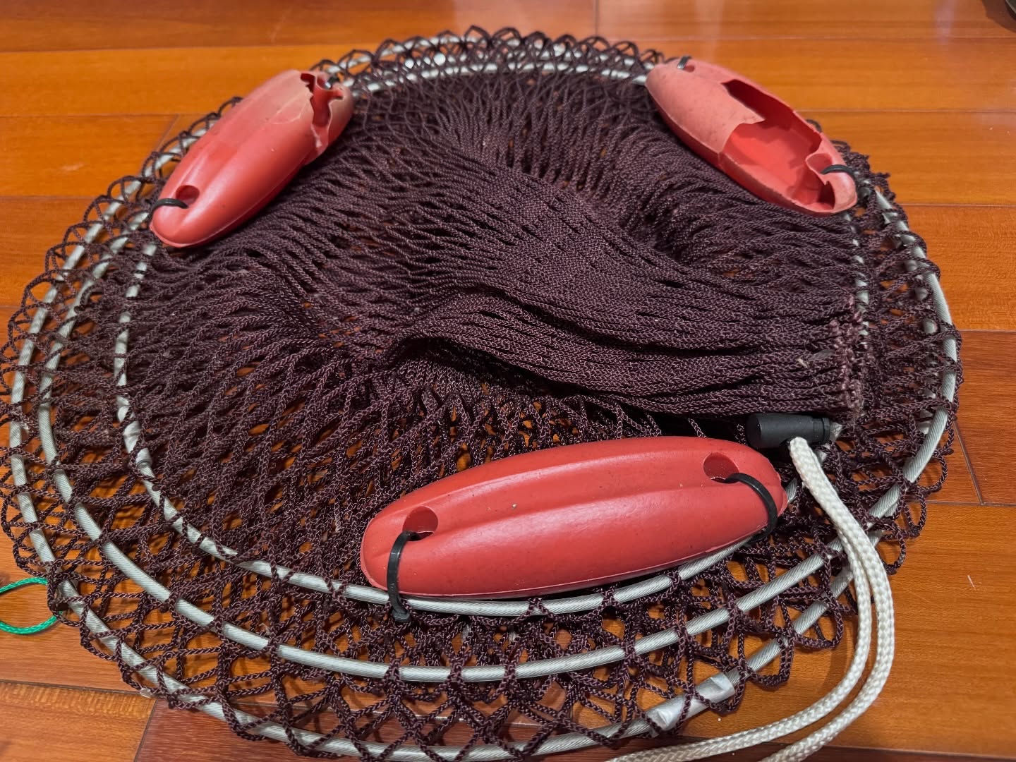 Repairing a Cast Net with Floats the Sea Threw Back