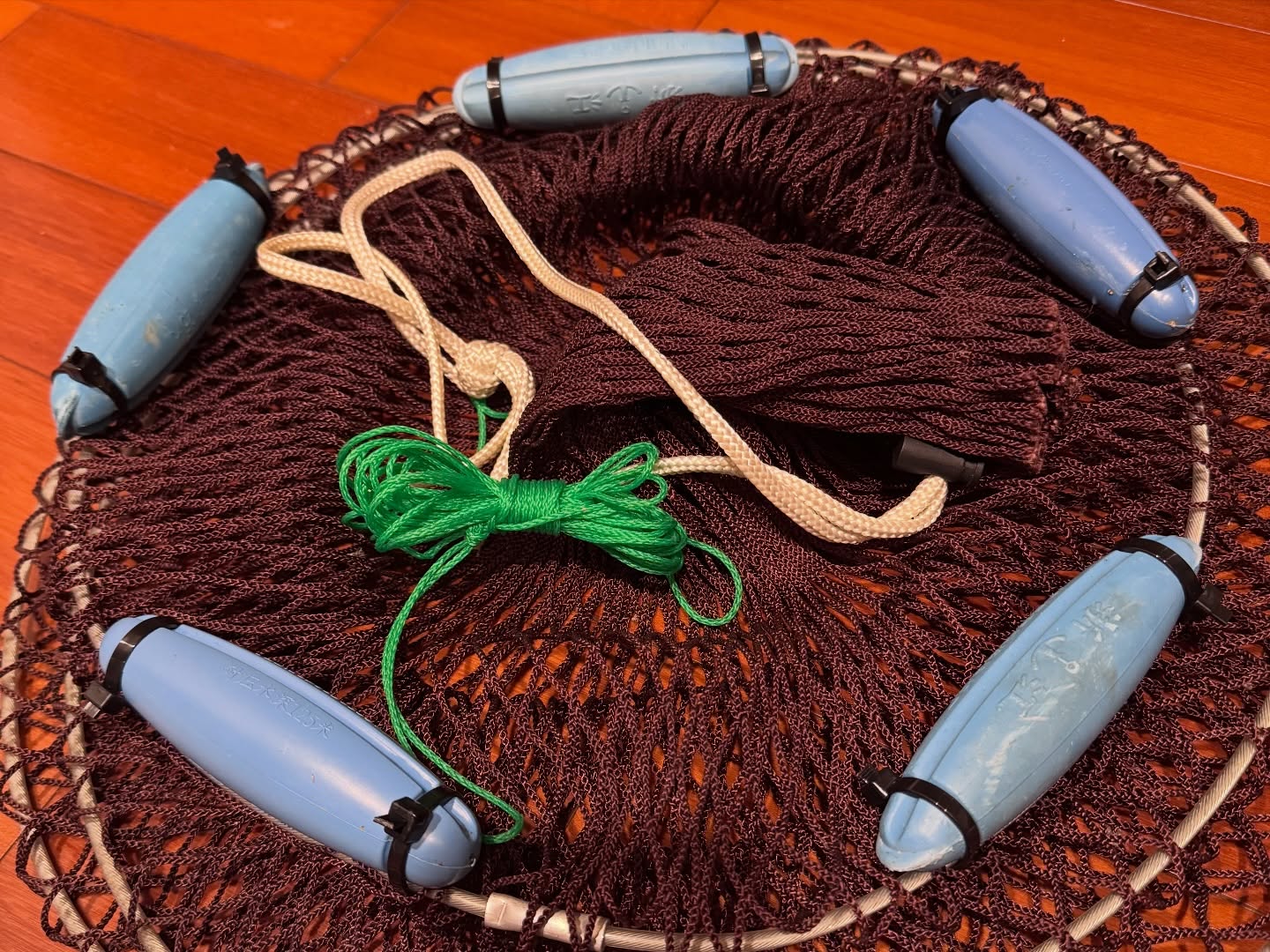 Repairing a Cast Net with Floats the Sea Threw Back